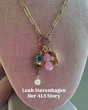 Necklace with floral charm on a mannequin bust, featuring 'Leah Stavenhagen Her ALS Story'.
