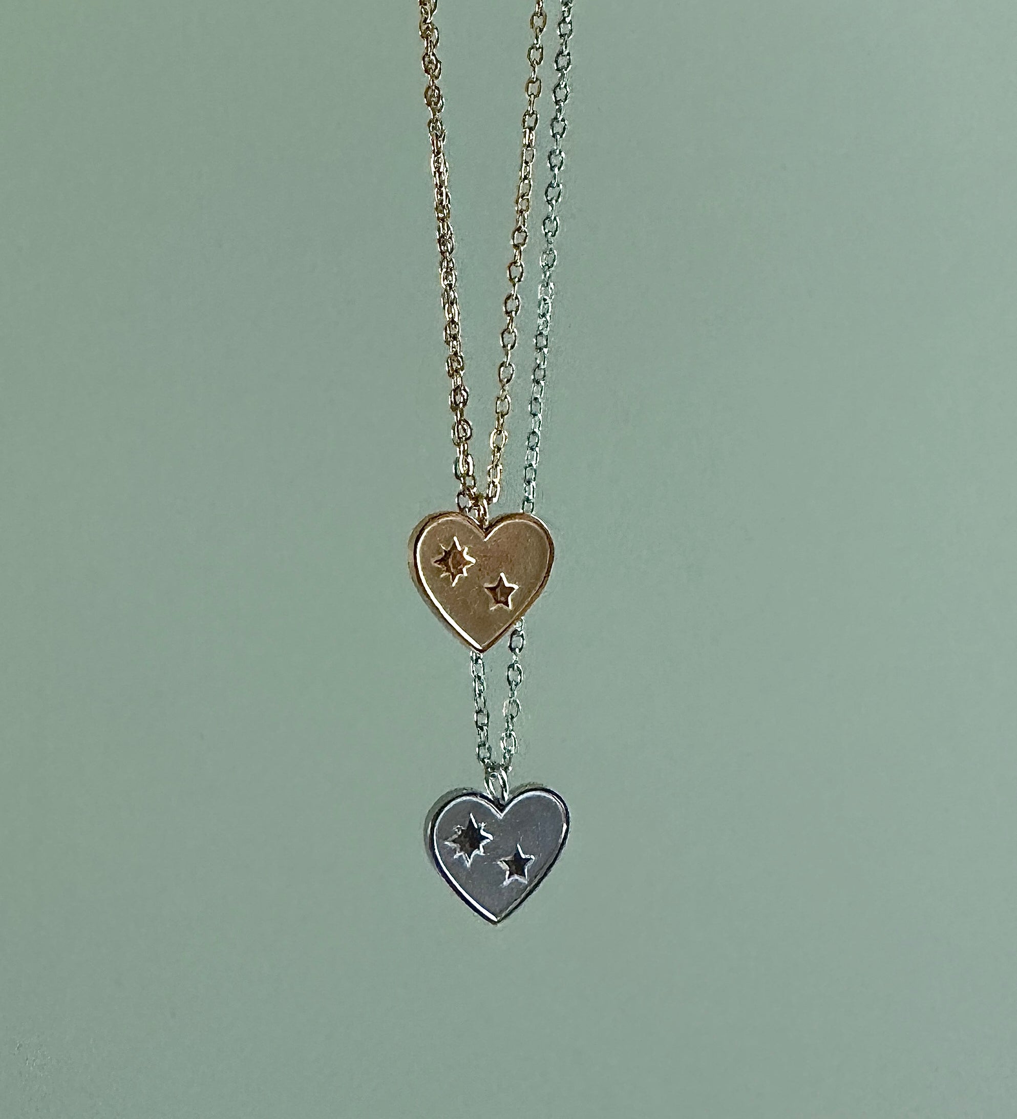Necklace with heart-shaped pendants on a light green background