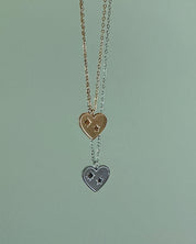 Necklace with heart-shaped pendants on a light green background
