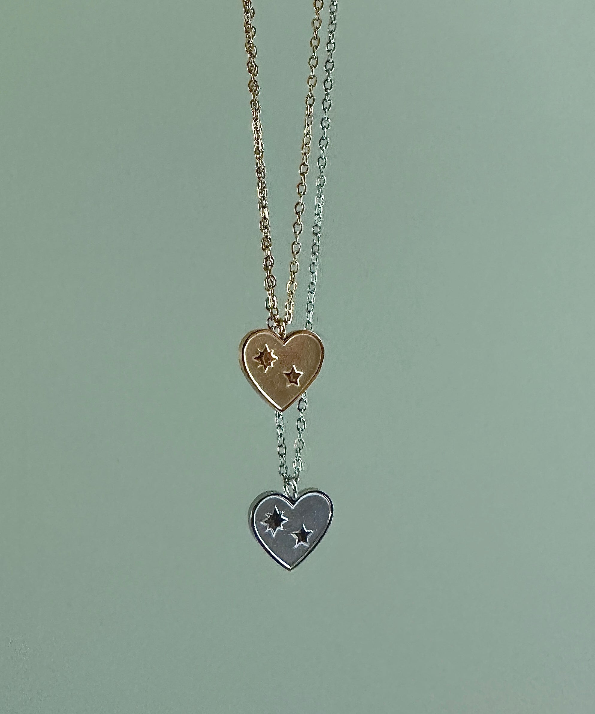 Necklace with heart-shaped pendants on a light green background