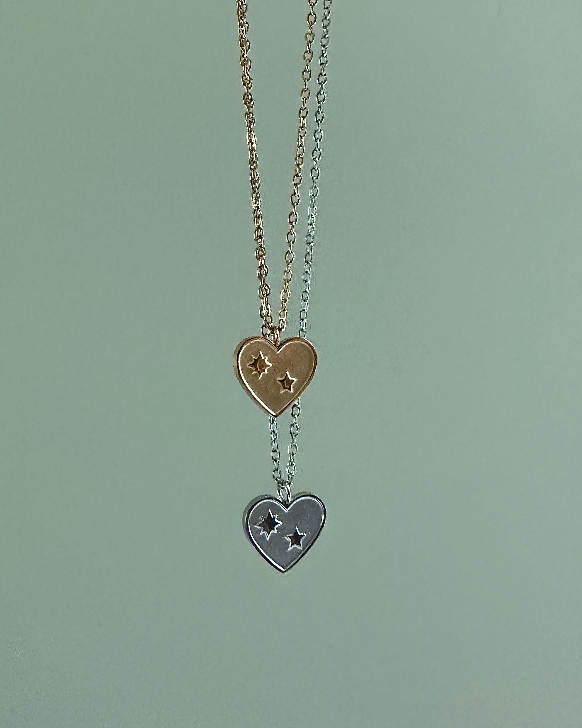Necklace with heart-shaped pendants on a light green background