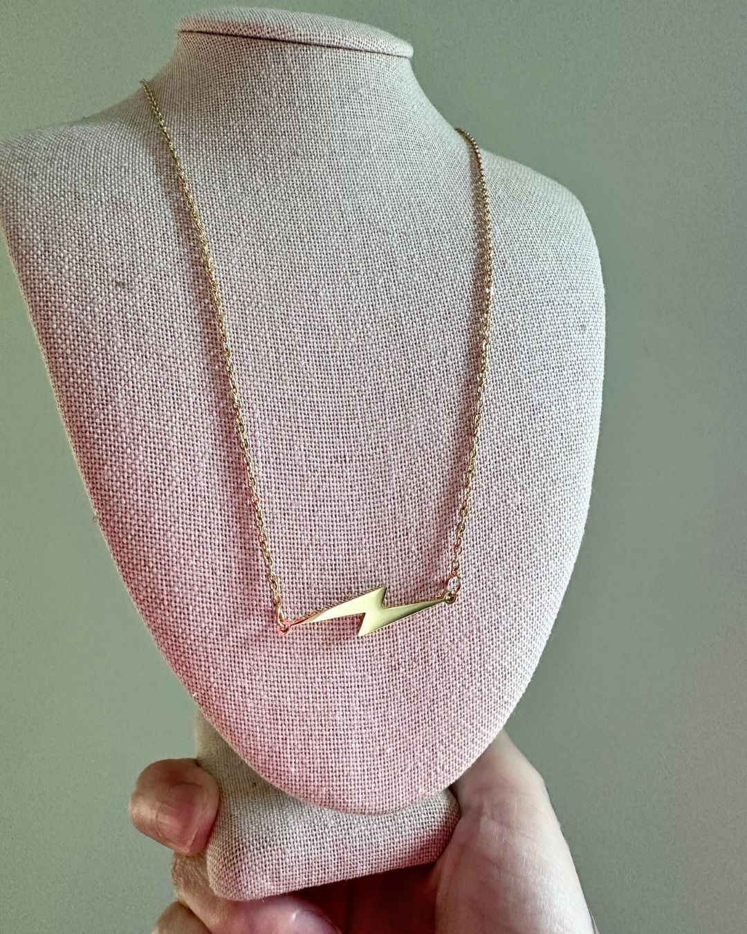 gold lightning bolt necklace on neck display