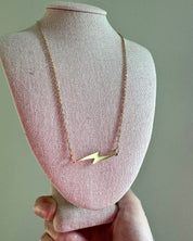 gold lightning bolt necklace on neck display